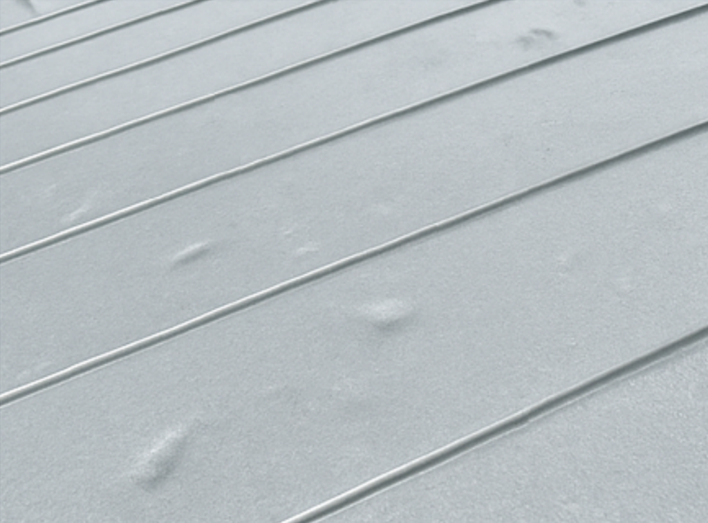Grey metal roofing with a lump