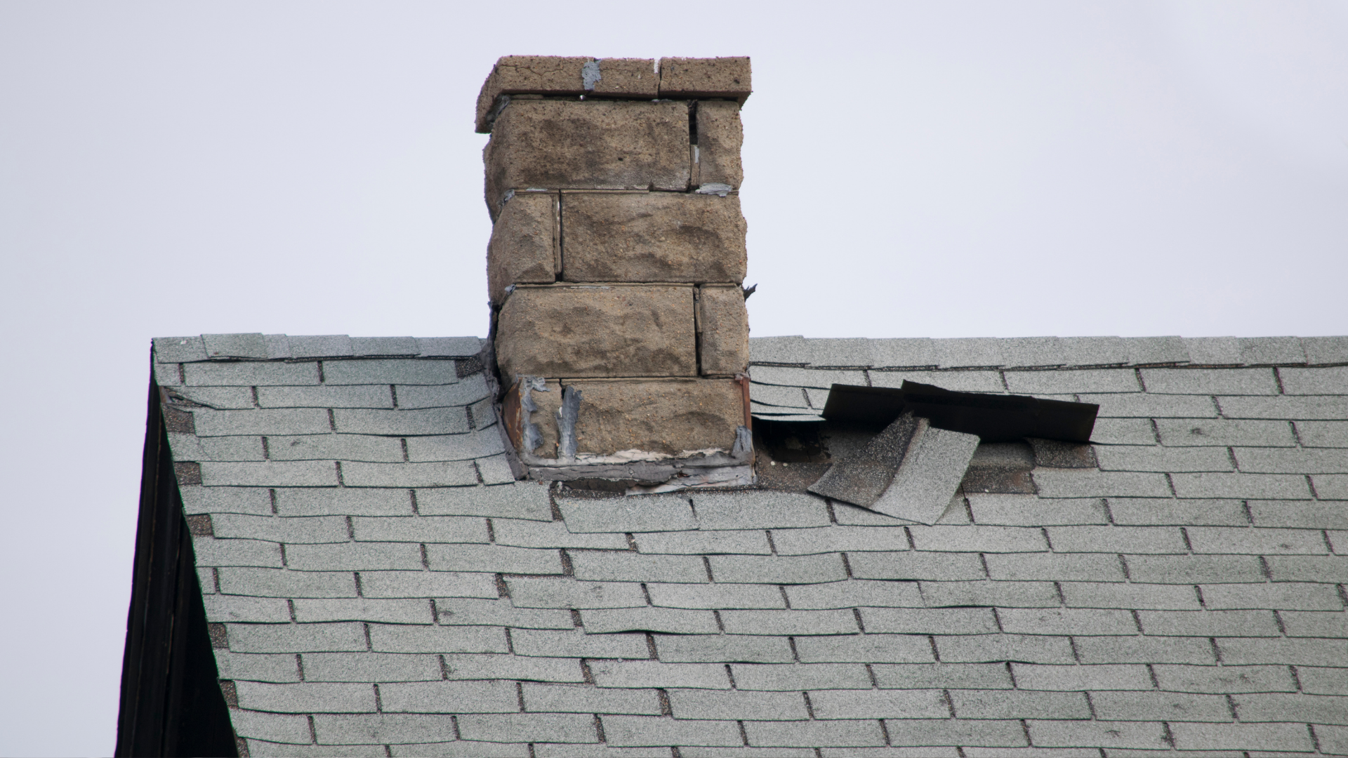 Broken tile roof near the chimney.