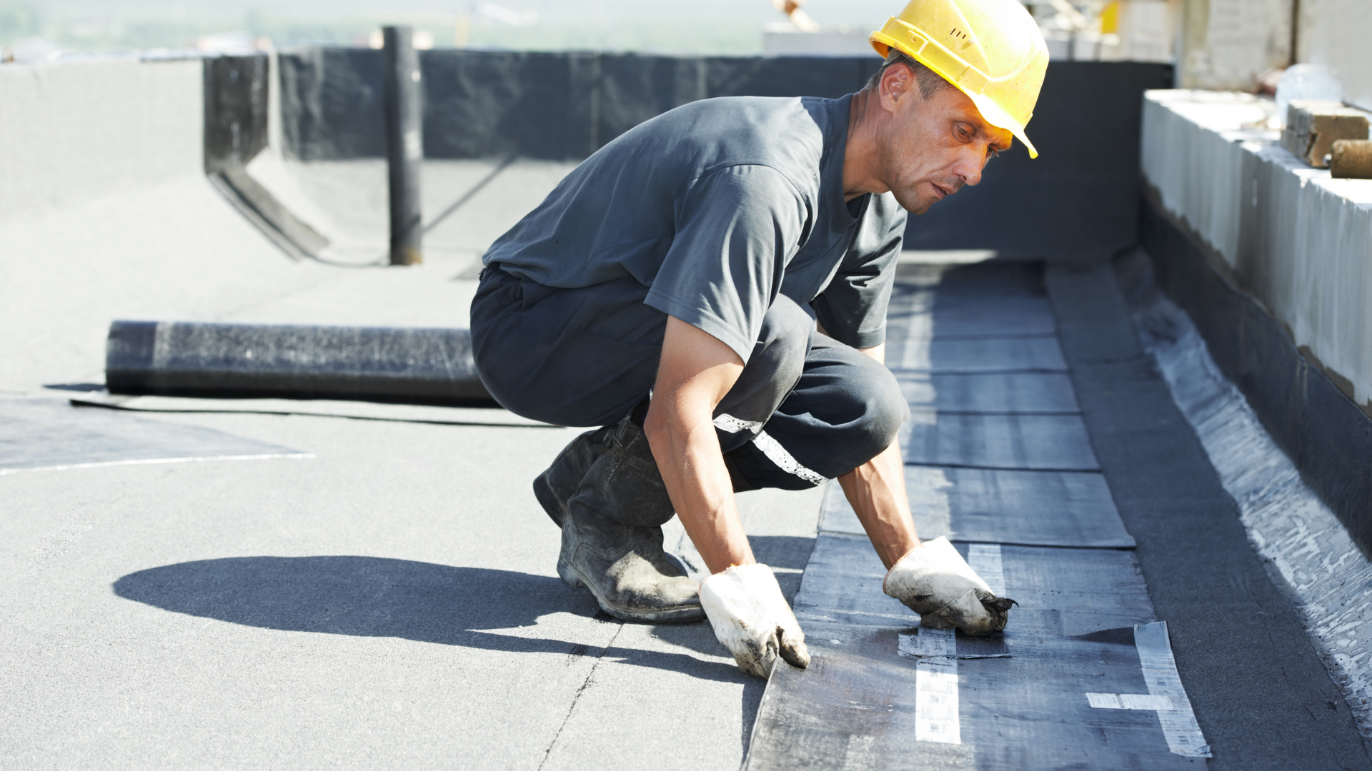 A man fixing a commercial metal roof.